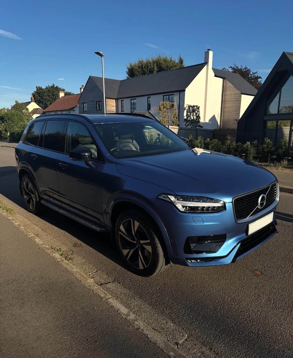 Blue Volvo XC90 parked on a residential street